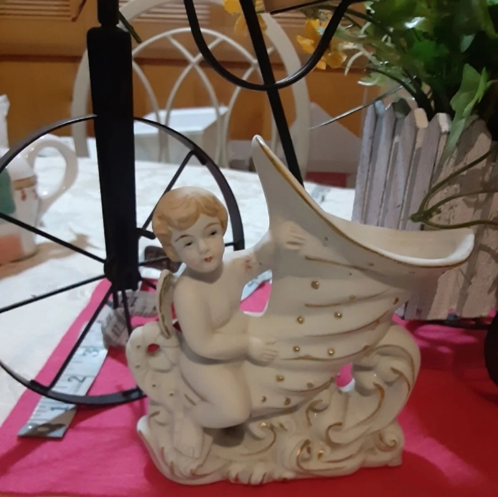 Cherub riding a wave made in Japan